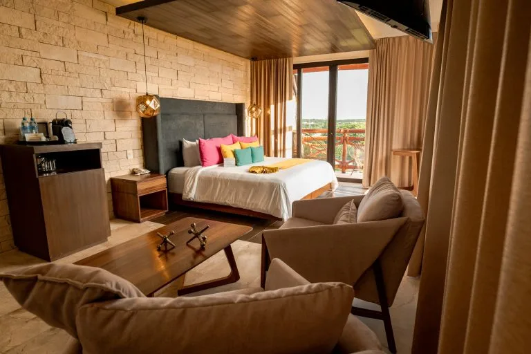 Guestroom with wooden ceiling, bed and sofa — Esplendor by Wyndham Isla Mujeres Boutique All Inclusive